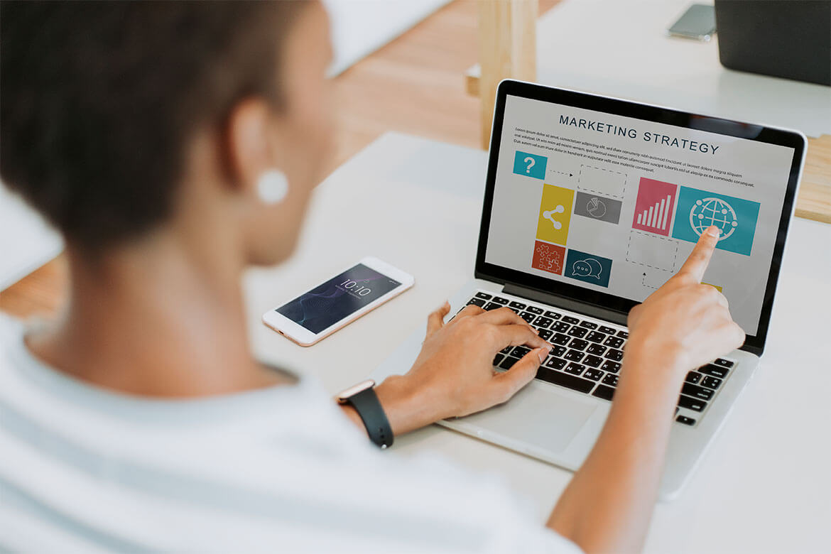 A person working on a laptop displaying a comprehensive marketing strategy with various colorful icons and graphs. Their right hand is pointing at a globe icon on the screen, symbolizing global outreach. Nearby, a smartphone shows the time as 10:10. This scene captures the essence of performance marketing executed by a leading digital marketing company. A person working on a laptop displaying a comprehensive marketing strategy with various colorful icons and graphs. Their right hand is pointing at a globe icon on the screen, symbolizing global outreach. Nearby, a smartphone shows the time as 10:10. This scene captures the essence of performance marketing executed by a leading digital marketing company.